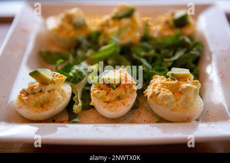 Deviled Eggs topped with avocado Stock Photo