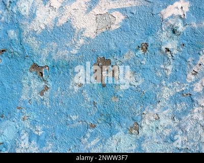 Faint blue painting remnant on the brick wall of an old building. Wall background in design loft style. Grunge colored with copy space. partly damaged Stock Photo