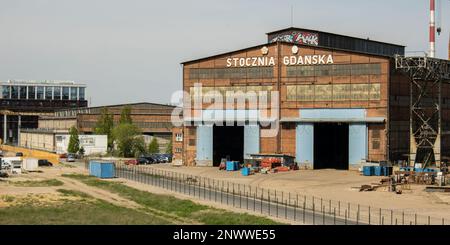 Gdansk, Poland - July 19 2022: Industrial building at the Gdansk Shipyard, former Lenin Shipyard, prefabrication workshop and heavy cranes large Polish shipyard. Cranes at historical shipyard in Gdansk headquarters of Solidarity Polska Stock Photo