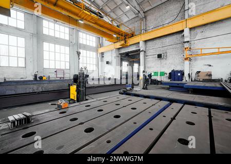Long steel constructions assembling with welding in workshop Stock Photo