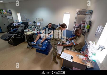 Staff Sgt. Season Bachman (middle), 379th Expeditionary Medical Support Squadron laboratory technician, collects samples from a patient for pre-screening, Jan. 24, 2023, at Al Udeid Air Base, Qatar. Since platelets only last for 5-7 days, there is a continuous need for donors to participate in AUAB’s apheresis program. The platelets collected are shipped to two locations within the U.S. Central Command Area of Responsibility. Stock Photo