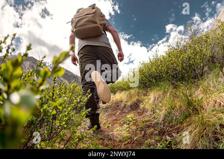 Closeup photo of walking hiker legs on the mountain trail Stock Photo