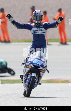 Spain s Jorge Martin celebrates on the podium after winning the