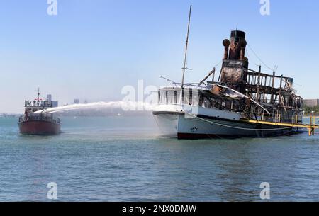 Members of the Detroit Fire Department Marine Corps spray water on the SS  Ste. Claire that was on fire at a marina in Detroit, on Friday, July, 6,  2018. The blaze on