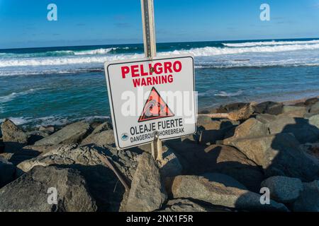 Dangerous beach sign in the beach in Piñones Loiza Puerto Rico Stock Photo