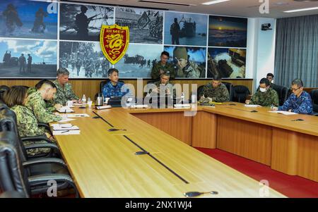 U.S. Navy Rear Adm. Derek Trinque, commander, Task Force 76/3, left ...