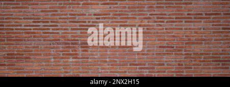 Texture of the wall of thin long red bricks Stock Photo