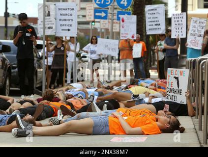 Around 50 protesters from 'We The Students' and 'March For Our Lives, Tampa' demonstrate in front of Marco Rubio's office in Tampa Tuesday, June 12, 2018. They rallied against gun violence for an hour before staging a 'die in' on the sidewalk in silent protest for 12 minutes. (James Borchuck/The Tampa Bay Times via AP)