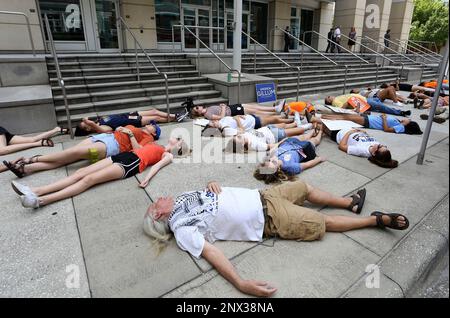 Around 50 protesters from 'We The Students' and 'March For Our Lives, Tampa' demonstrate in front of Marco Rubio's office in Tampa Tuesday, June 12, 2018. They rallied against gun violence for an hour before staging a 'die in' on the sidewalk in silent protest for 12 minutes. (James Borchuck/The Tampa Bay Times via AP)