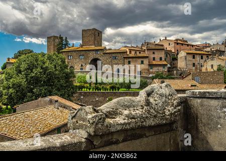 View of Tuscania from Piazza Bastianini and Etruscan sarcophagus. Tuscania, Viterbo province, Lazio, Italy, Europe Stock Photo