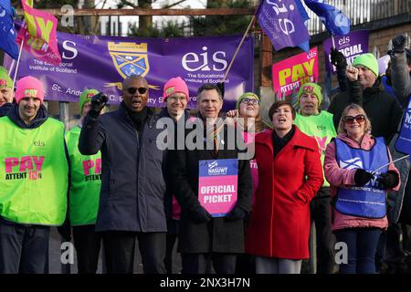 (front, left to right) Dr Patrick Roach general secretary of National Association of Schoolmasters Union of Women Teachers (NASUWT), NASUWT National Official for Scotland Mike Corbett, and Scottish Trades Union Congress (STUC) general secretary Roz Foyer, with teachers on the picket line outside St. Andrew's RC Secondary School, in Glasgow, as they take strike action in a dispute over pay. Picture date: Wednesday March 1, 2023. Stock Photo