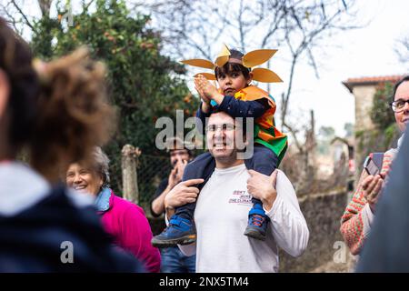 Montalegre, Portugal. 19th Feb, 2023. A father and his son are seen watching the celebrations of Carnival Entrudo of Misarela. Entrudo da Misarela is a socio-cultural dynamization project that aims to bring the two banks of Rabagão closer together, around the same idea: to recreate Entrudo as a celebration of the 'entrance' of Spring. The event happens in the Misarela bridge, a bridge that was built in the middle ages, located in Montalegre in the North East of Portugal. (Photo by Telmo Pinto/SOPA Images/Sipa USA) Credit: Sipa USA/Alamy Live News Stock Photo