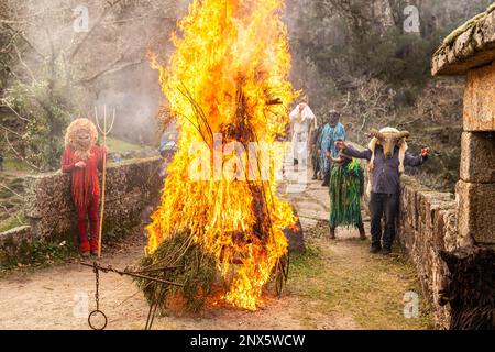 Montalegre, Portugal. 19th Feb, 2023. Caretos de Misarela are seen near the burning Entrudo, the last ritual of the celebrations. Entrudo da Misarela is a socio-cultural dynamization project that aims to bring the two banks of Rabagão closer together, around the same idea: to recreate Entrudo as a celebration of the 'entrance' of Spring. The event happens in the Misarela bridge, a bridge that was built in the middle ages, located in Montalegre in the North East of Portugal. (Photo by Telmo Pinto/SOPA Images/Sipa USA) Credit: Sipa USA/Alamy Live News Stock Photo