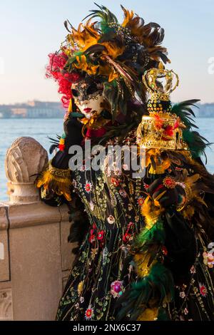 Carnival goer dressed in splendid costume and mask during Venice Carnival 2023 at Venice, Italy in February Stock Photo