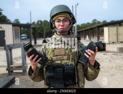 U.S. Air Force Outside the Wire pre-deployment training student, Tech. Sgt. Alyah Berger, carries her loaded magazines to her firing lane during live fire weapons training at Joint Base McGuire-Dix-Lakehurst, New Jersey, Feb. 7, 2023. OTW places students in realistic and strenuous training scenarios used to teach skills such as weapons control, combative techniques, communications, mounted and dismounted movements and land navigation. Stock Photo