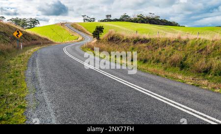 Winding road through Adelaide Hills farms during winter season, South Australia Stock Photo