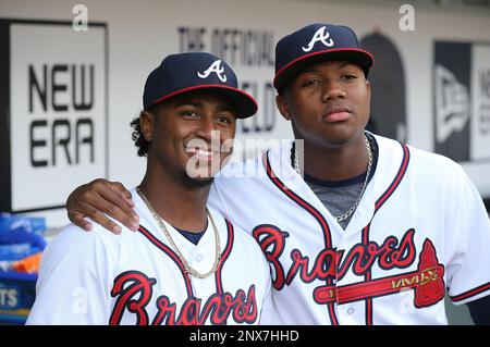 Ozzie Albies of the Atlanta Braves laughs in the dugout during the