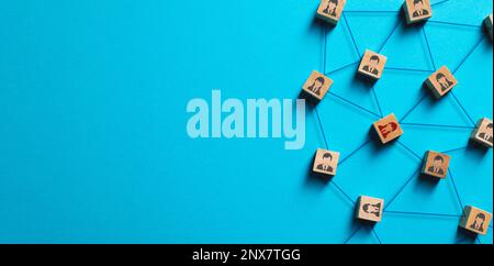 Organization structure, social network and teamwork concept on blue background. Business people icon on wooden cube blocks connecting network of conne Stock Photo