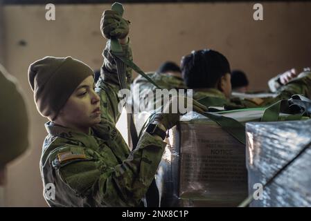 A U.S. Army Soldier assigned to the 5th Quartermaster Theater Aerial Delivery Company prepares Container Delivery System (CDS) bundles for transport onto the ramp of a C-130J Super Hercules aircraft during exercise Chasing Sol in Zaragoza, Spain, Jan. 24, 2023. Members of the 86th Airlift Wing, 435th Air Ground Operations Wing, and Soldiers assigned to the 21st Theater Sustainment Command’s 16th Sustainment Brigade are in Zaragoza to participate in exercise Chasing Sol with the Spanish air force. Stock Photo