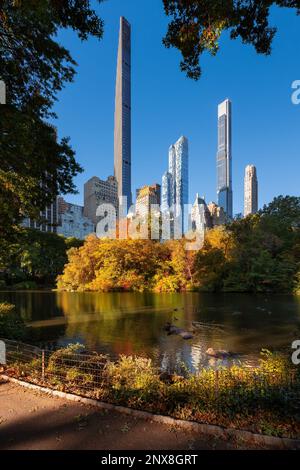 Central Park by The Pond in Fall with Billionaires Row skyscrapers. Midtown Manhattan, New York City Stock Photo