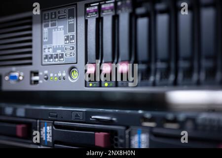 rack-mounted server with hard disk slots, green LED illuminated buttons and depth of field Stock Photo