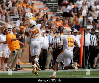 Orange team wide receiver Josh Palmer (5) makes a catch over White team  defensive back Marquill Osborne (3) during the Orange and White spring game  at Neyland Stadium on Saturday, April 21