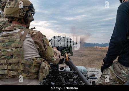 A 304th Rescue Squadron pararescueman fires an Mk 19 grenade launcher downrange at Fort Stewart, Georgia, during combat arms training Jan. 21, 2023. The Mk 19 is a man-portable crew-served weapon that can fire from a tripod-mounted position or from a vehicle mount. Stock Photo