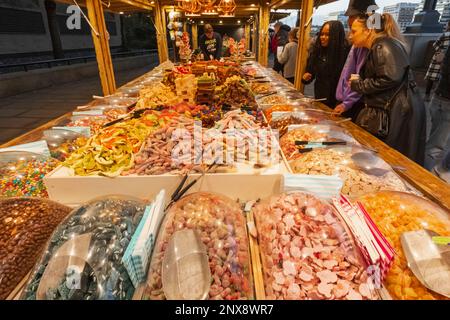 England, London, Southwark, Riverside Christmas Market, Retail Stall Display of Colourful Traditional Sweets Stock Photo