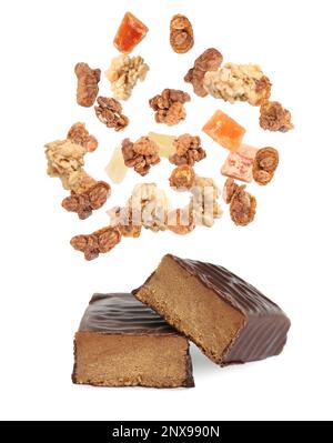 Tasty chocolate glazed protein bars and granola with dried fruits falling on white background Stock Photo