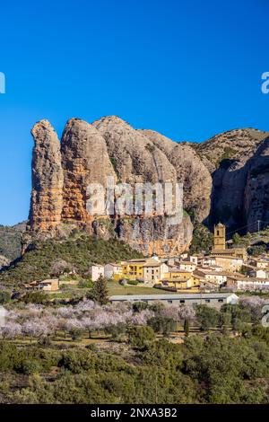 View of the village with the Mallos de Aguero rock formations behind ...