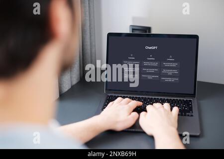 Lisbon, Portugal - March 01, 2023: Screen with ChatGPT chat with AI or artificial intelligence. Man chatting with AI, search for information using artificial intelligence Stock Photo