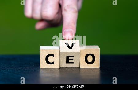 Hand turns cubes and changes the abbreviation CEO (chief executive officer) to CVO (Chief Visionary Officer). Stock Photo