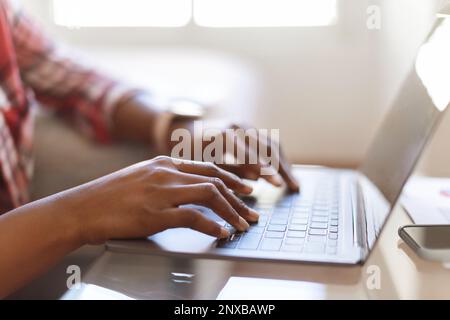 Black woman hands typing on pc laptop keyboard, cropped Stock Photo
