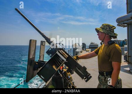 230203-N-TC338-1017  BAB AL-MANDEB (Feb. 3, 2023) Information Systems Technician 2nd Class Brittany Desilets, from Oklahoma City, stands watch aboard the Lewis B. Puller-class expeditionary sea base USS Hershel 'Woody' Williams (ESB 4), while transiting through the Bab al-Mandeb (BAM) strait in company with the Cyclone-class coastal patrol ship USS Hurricane (PC 3), Feb. 3, 2023. Hershel 'Woody' Williams is on a scheduled deployment in the U.S. Naval Forces Africa area of operations, employed by U.S. Sixth Fleet to defend U.S., Allied and partner interests. Stock Photo