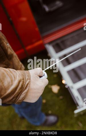Low section of retired senior man holding remote control with antenna Stock Photo