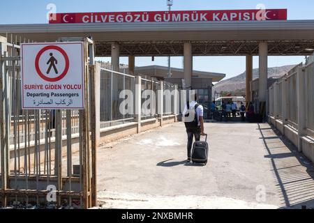 Male Syrian refugee returning to the secured area in his country. Syrian refugee crossing into Syria through the Cilvegözü border gate in Turkey. Stock Photo