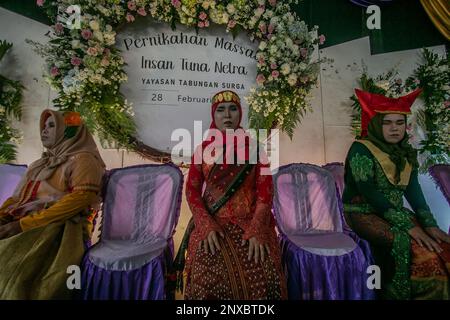 Bogor, Indonesia. 28th Feb, 2023. Blind bride take part on a procession wedding during a mass marriage for visually impaired in Bogor, West Java, Indonesia on February 28, 2023. Twelve blind couples got married for free by a social foundation to help economically disadvantaged people with disabilities get legal. (Photo by Andi M Ridwan/INA Photo Agency/Sipa USA) Credit: Sipa USA/Alamy Live News Stock Photo