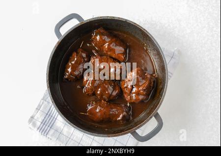 German beef roules with brown gravy or sauce fresh and homemade cooked in a roasting pan. Preparation, cooking, making. Part of a series Stock Photo