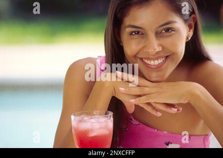Woman by swimming pool smiling, close-up, portrait Stock Photo
