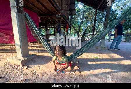 A young child plays on a hammock in a village in rural Siem Reap province in Cambodia. Stock Photo