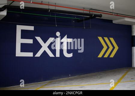 Under ground parking area exit sign painted on wall Stock Photo