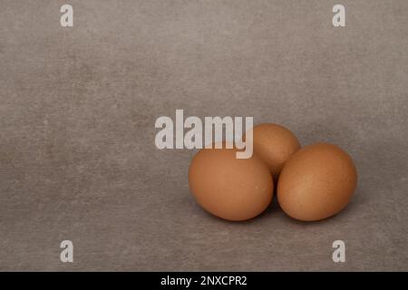 Three eggs isolated on gray background Stock Photo