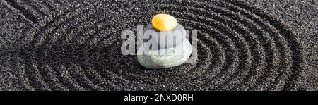 Japanese zen garden with stone in textured sand Stock Photo