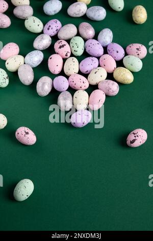 photo quail eggs made of foam plastic lying on a green paper background Stock Photo