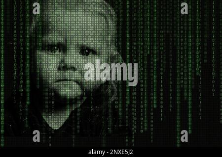 A child's serious face with matrix digital numbers is an AI artificial intelligence theme with a human face. Children's Internet addiction. Virtual re Stock Photo