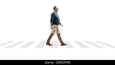 Full length profile shot of a mature man crossing street on a pedestrian sign isolated on white background Stock Photo