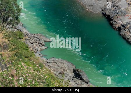 Bhagirathi river from left side and Alakananda river with turquoise blue colour from right side converge at Devprayag,Holy conflunece,Himalays, India. Stock Photo