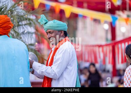 Noida Haat, India: Portrait on unidentified male artist performing folk dance of haryana in colorful ethnic dress with smile and expressions. Stock Photo