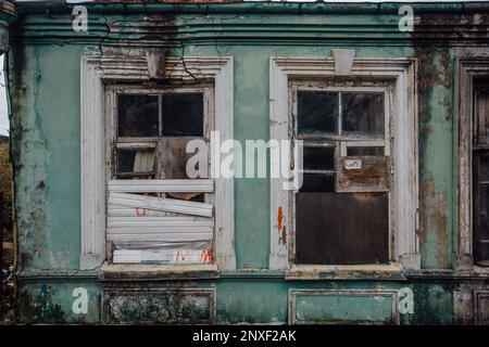 Boarded up windows of abandoned house. Stock Photo