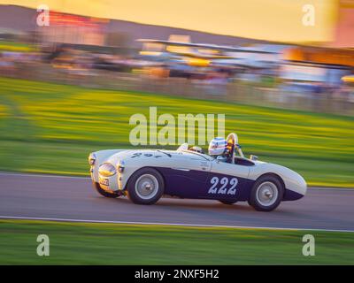 1955 Austin Healey 100S  racing at sunset at the Goodwood Revival 2022, West Sussex, uk Stock Photo